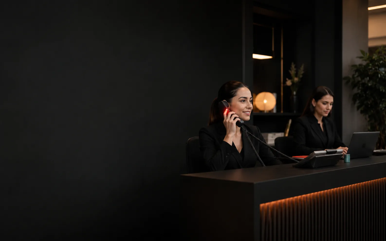 Receptionist welcoming a smiling patient at a modern dental clinic front desk